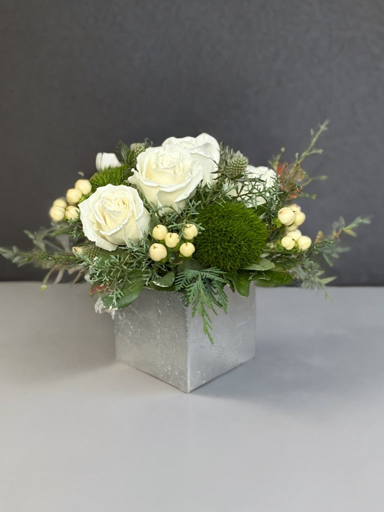 Let it snow - White roses and winter greens shine with purity of the first snow