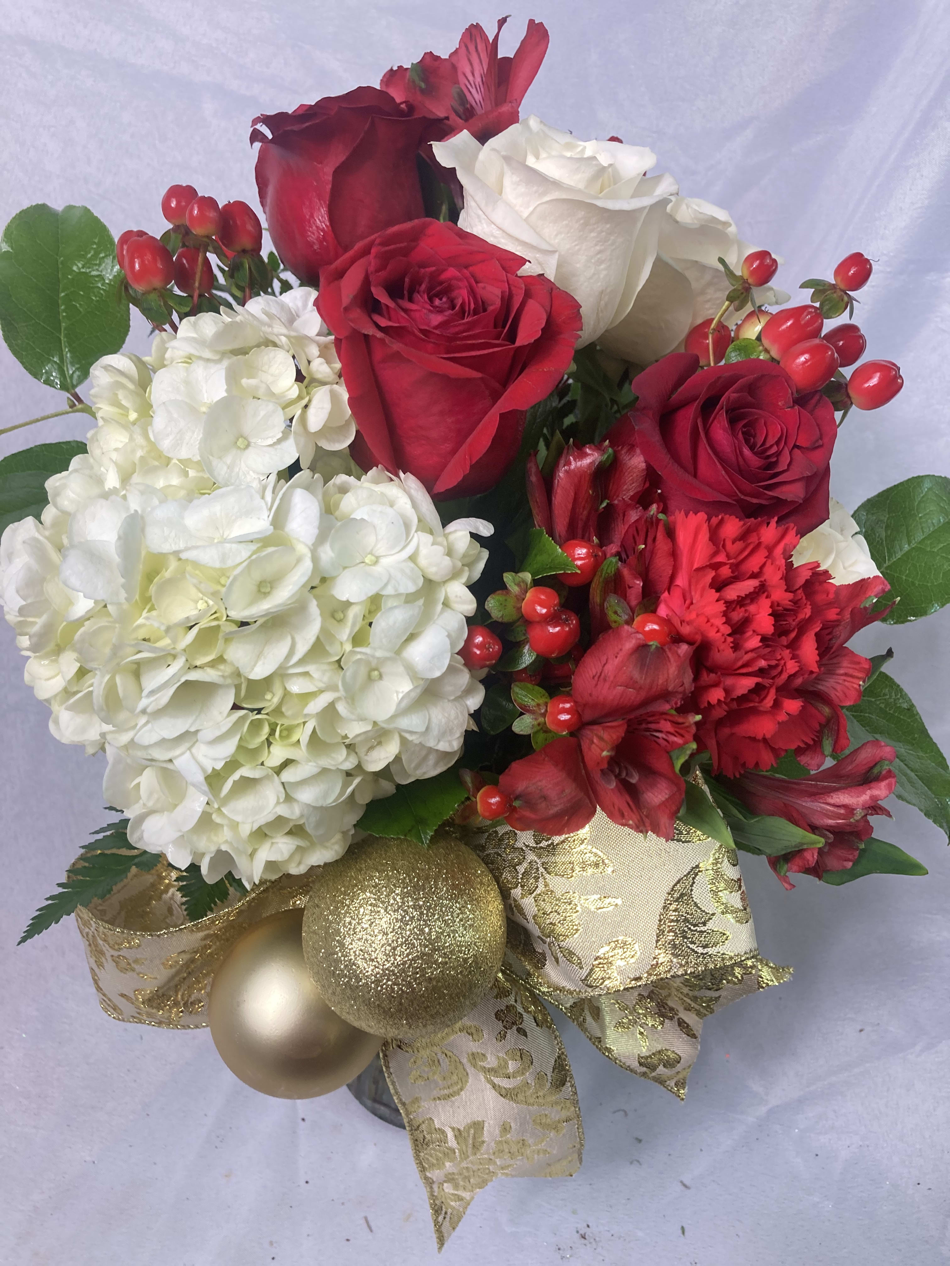 Home for the Holidays  - Classic Christmas bouquet of Roses, berries, Pinecones,  Cedar, Hydrangea mix that is reminiscent of home. Just what someone needs this holiday season. 