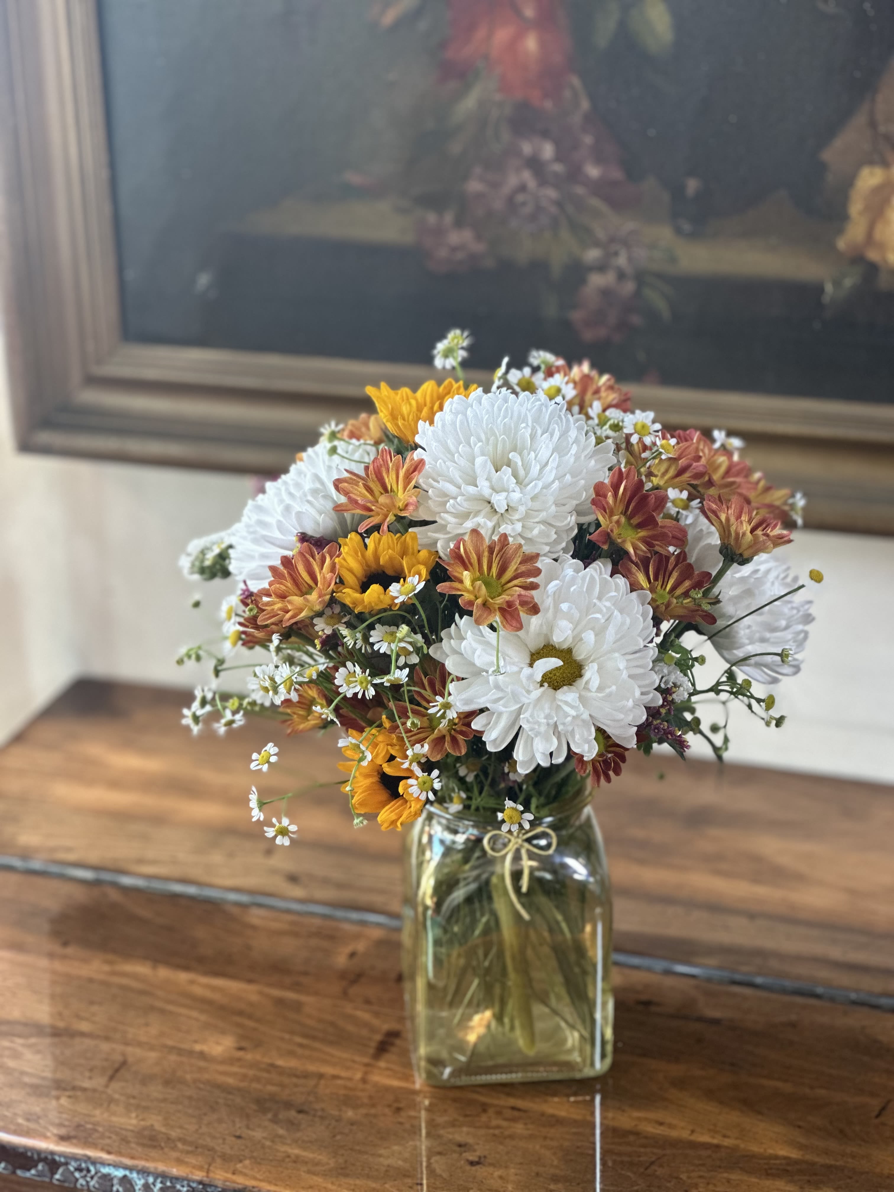 Get Well Soon  - Send healing thoughts and warm wishes with our cheerful Get Well Soon arrangement. This uplifting bouquet features bright white chrysanthemums, sunny yellow blooms, and soft coral accents designed to brighten any hospital room or home recovery space. Each arrangement is lovingly hand-crafted with fresh, long-lasting flowers that bring comfort and joy during recovery.  Perfect for hospital visits, post-surgery recovery, or letting someone know you’re thinking of them during a difficult time. Available for same-day delivery throughout Venice, FL. The flowers are artfully arranged in a vintage-inspired yellow-tinted glass vase.  