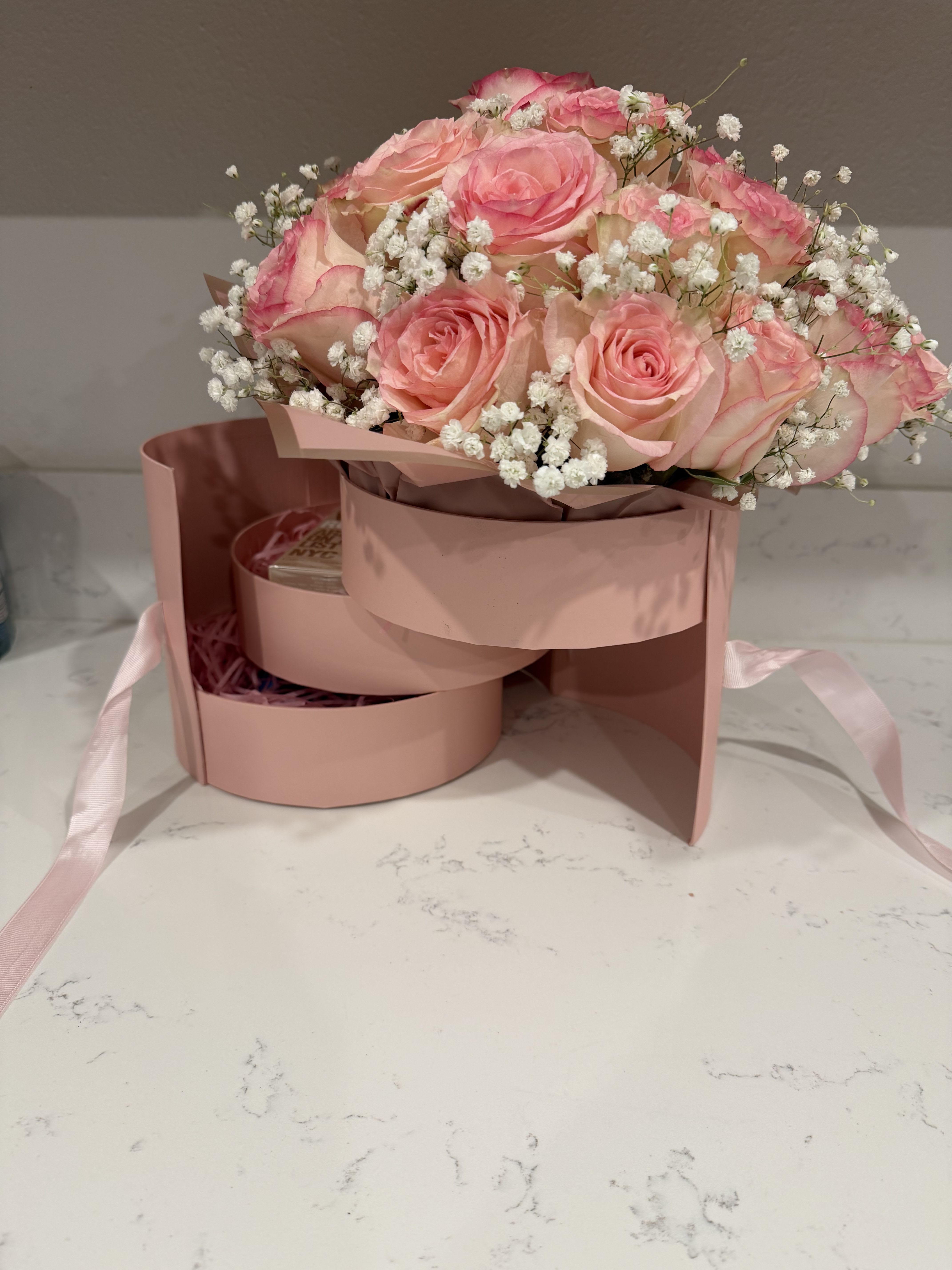 Blooming Blush Treasure Box - This luxury bloom box features premium pink roses with soft baby’s breath, arranged in a blush gift box designed with internal compartments for placing small gifts, chocolates, jewelry, or personalized surprises. A sophisticated and memorable gift for any occasion.