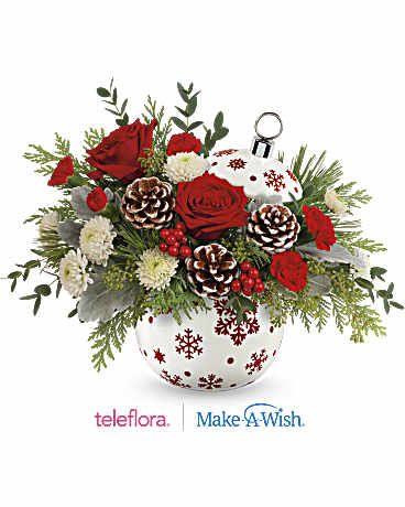 Teleflora's Sprinkle Sparkle - Capture the essence of a classic Christmas with stunning red roses and fresh white pine elegantly arranged in a shimmering, hand-painted ceramic ornament jar-a gift they'll cherish forever. Celebrate the holidays with this festive bouquet featuring red roses, red carnations, miniature red carnations, cedar, dusty miller, and noble fir. Teleflora's Sparkle All The Way Bouquet is elegantly delivered in Teleflora's Sprinkle Sparkle Ornament, adding a touch of seasonal charm to your celebrations.   SUBSTITUTION POLICY – Always deliver the freshest flowers! Please note the bouquet pictured reflects our original design.  If the exact flowers or container in this arrangement are not available, our local florists will create a beautiful bouquet with the freshest available flowers.