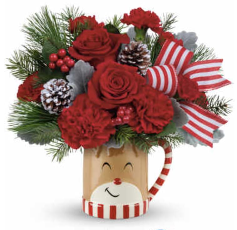 A Hug Reindeer - Overflowing with festive blooms, this adorable reindeer delivers your holiday wishes! This delightful bouquet showcases red roses, red carnations, miniature red carnations, dusty miller, douglas fir, and white pine. 