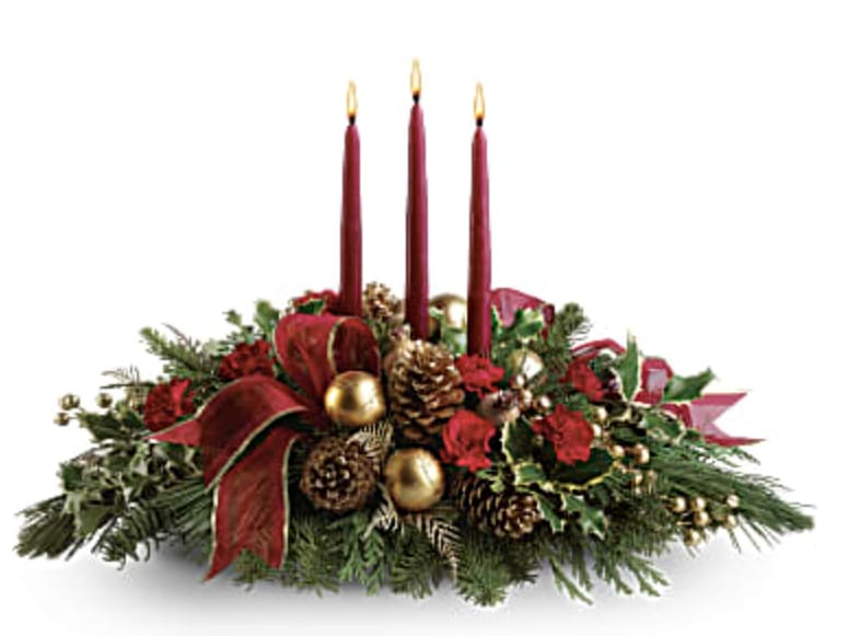 All Is Bright - All is calm, all is bright…well, at least we can promise the latter with this luminous arrangement! Gather family and friends together for a holiday meal around this traditional Christmas centerpiece featuring pinecones, holly, noble fir and Christmas candles. 'Tis the season to shine!