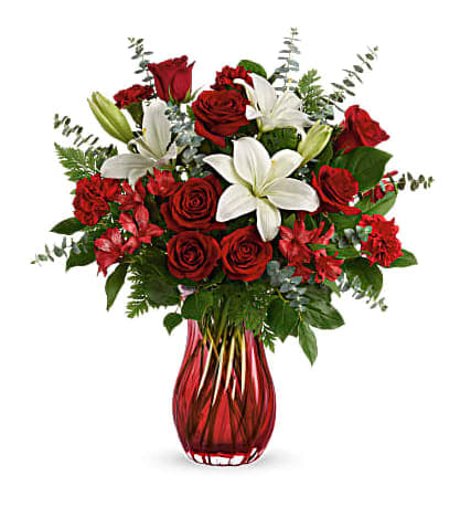 A Christmas Kiss Bouquet - Capture the romance of the season! Wonderful white hydrangea and rich red roses fill our stunning silver mercury glass royal vase. Its ruby red ombre hue is the perfect complement for ravishing red roses and snow white lilies.