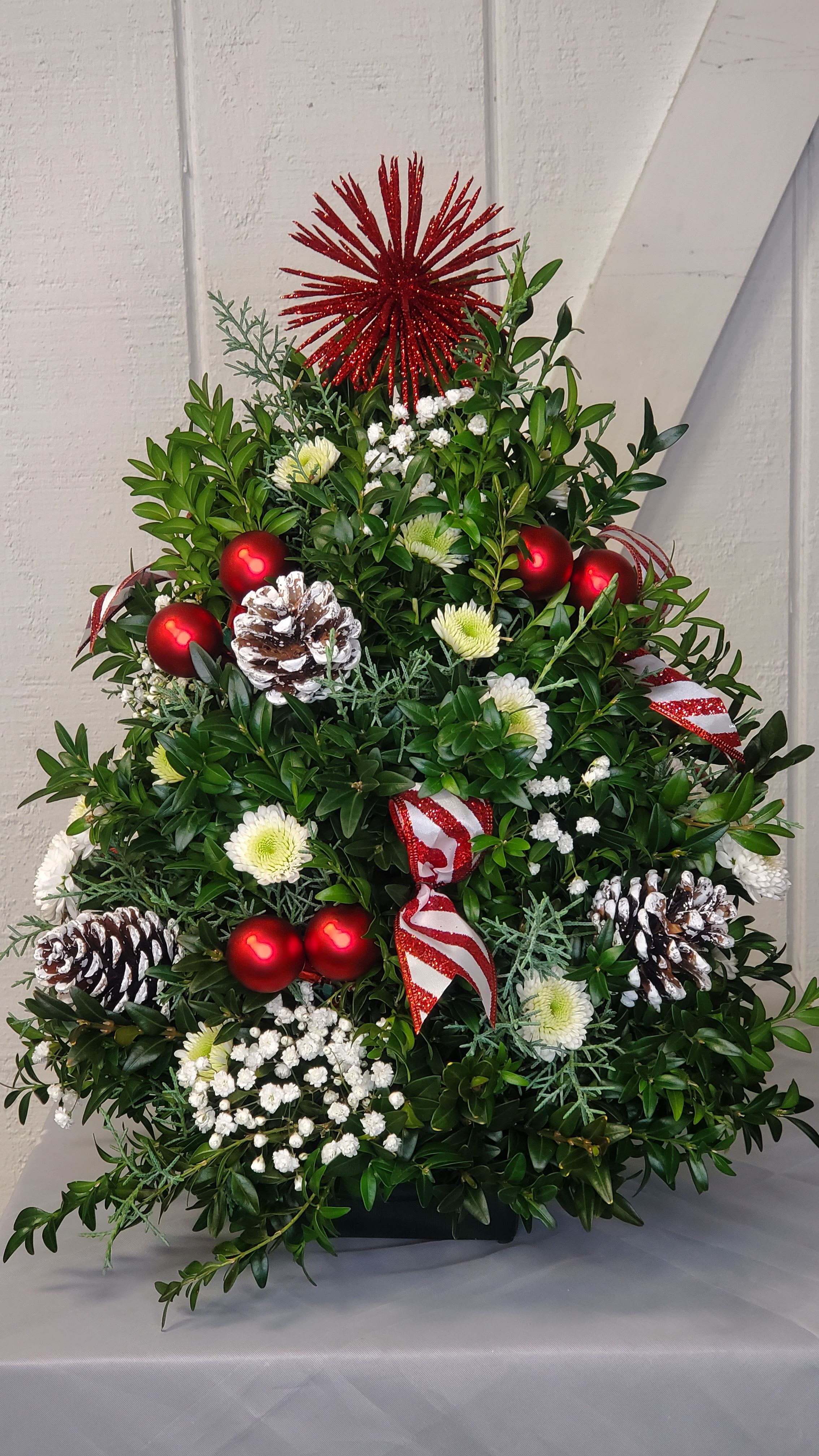 Boxwood tree - Colors can vary - if you have a specific color you would like please put in notes  Please Note: Each design is custom made and filled to value. We only use fresh product to ensure top quality so new orders are subject to substitution. Colors may vary.