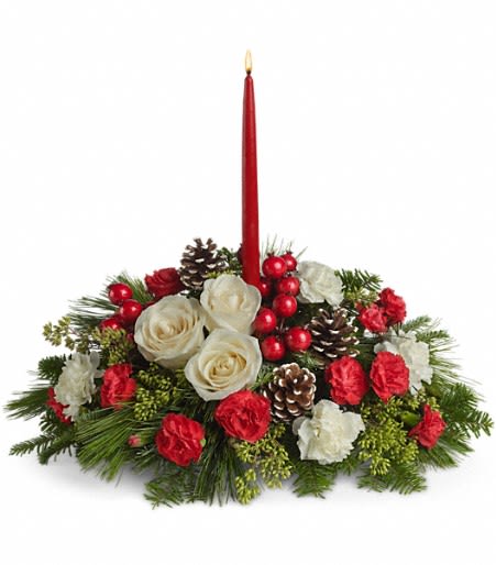 Christmas Aglow - The soft light of one simple red candle. The beauty of a gorgeous, sprawling Christmas arrangement of roses and carnations laced with pinecones, berries and more. What a beautifully sensational centerpiece! Imagine it on your table.  The elegant arrangement includes white roses, white carnations and red miniature carnations accented with eucalyptus, noble fir, white pine, pine cones and red berries. Comes with one red taper candle.  18&quot; H x 20&quot; W