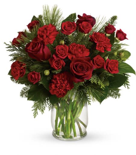 Pining For You - Surprise someone special this season! Radiant crimson flowers pop against a lush forest of winter greens in this gorgeous arrangement. It's a beautiful way to add a seasonal touch of brilliance to any room in the house. This bouquet pairs rich red roses and carnations with fresh winter greens including flat cedar, white pine, and noble fir.   Orientation: One-Sided 15&quot; H x 15&quot; W
