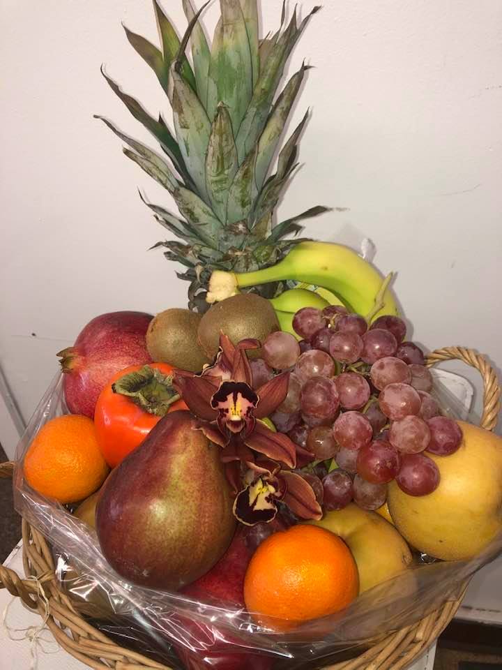 Fruit Baskets (with or without flowers) Gift Wrapped - A gracious offering of a bounty of Fruits. We usually start with a Pineapple a symbol of Hospitality and signifies Welcome, friendship and warmth. To this we add apples oranges tangerines grapes kiwis, pears of all sorts. Deluxe we will add nuts, Premium we will add cheese and crackers OR Super Premium we can add dried meats. Please make note in special instructions!! 