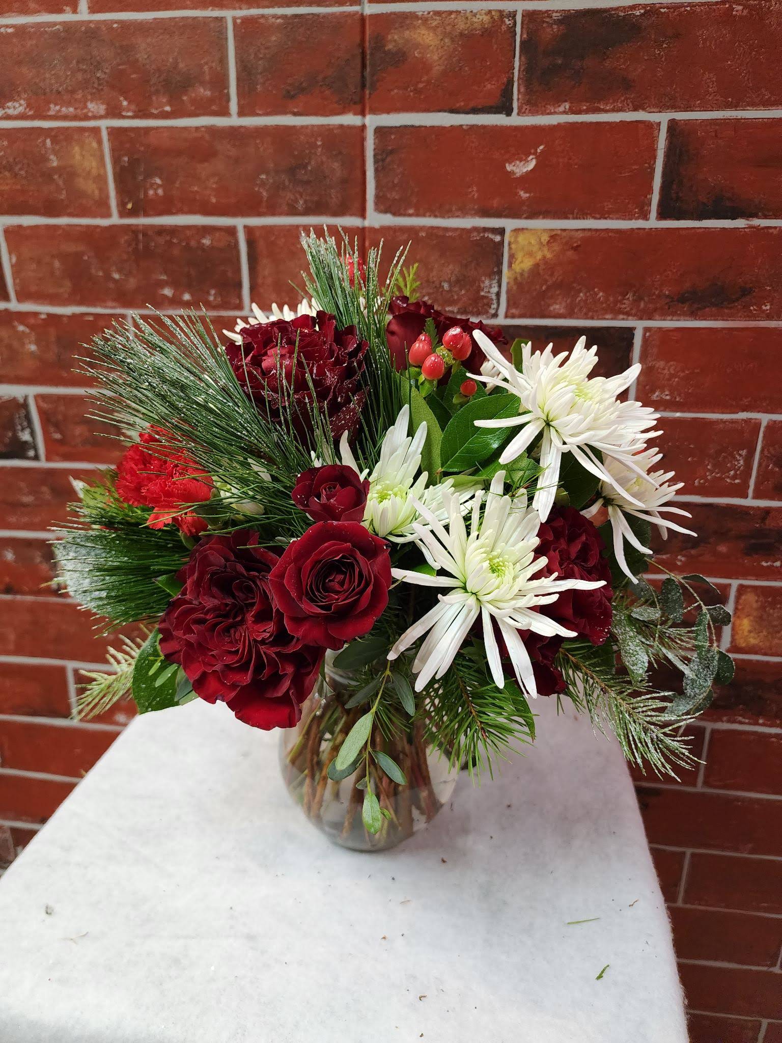 Winter Classic  - This bouquet is all around designed with spray roses, spider mums, Hypericum, and greenery  * Some stages of flower life may vary. (Example: Lilies may be more open than imaged.)  Flower shortages and product availability means that some substitutions will apply. Value will always be filled. This bouquet might include eucalyptus amongst the greenery. It may be toxic to pets including but not limited to Cats and Dogs if digested.