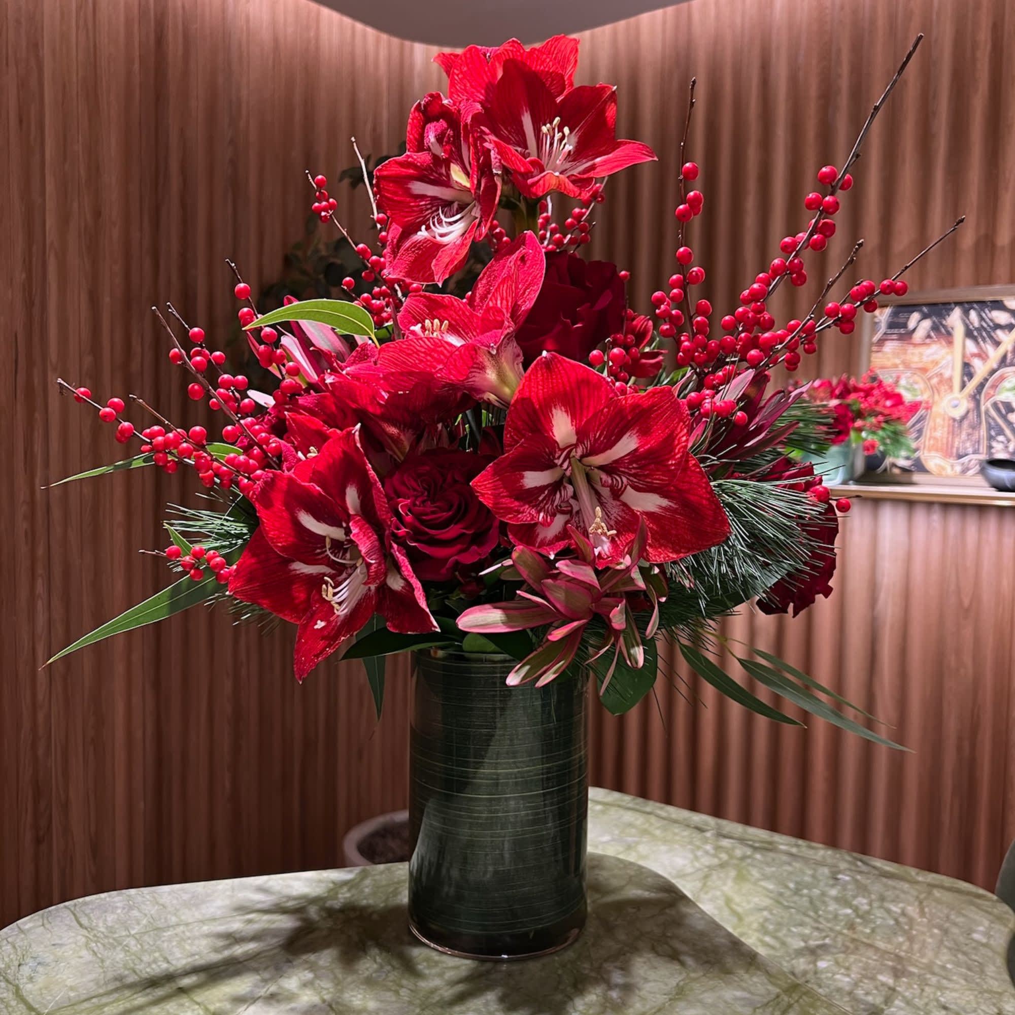 Festive Red Arrangement - Amaryllis, Roses and Christmas Branches in a tall vase (included)