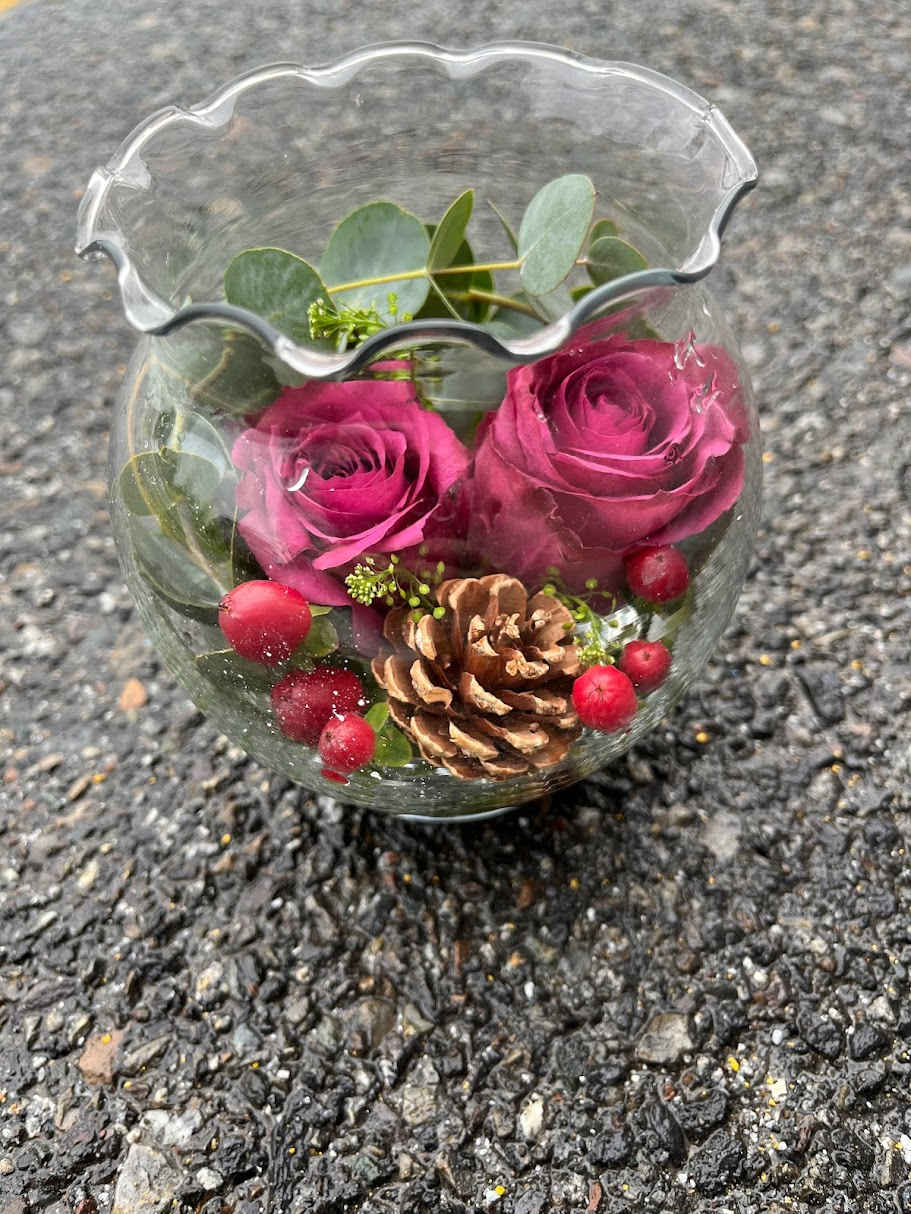 Traditional Rose Bowl- 2 roses winter theme - Traditional rose bowl. 2 roses winter theme with a pine cone and berries  * Some stages of flower life may vary. (Example: Lilies may be more open than imaged.)  Flower shortages and product availability means that some substitutions will apply. Value will always be filled. This bouquet might include eucalyptus amongst the greenery. It may be toxic to pets including but not limited to Cats and Dogs if digested.