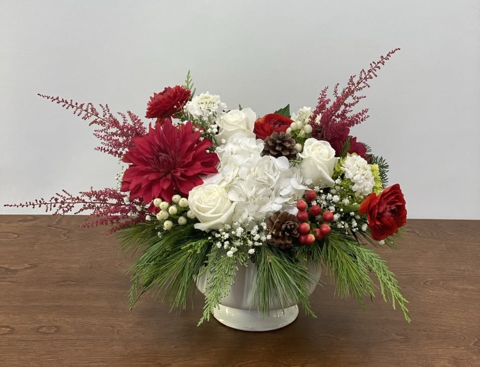 Festive Radiance - A elegant combination of classic red dahlia, ranunculus, and astilbe, paired with pristine white hydrangea, roses and scabiosa - creating a timeless centerpiece that is perfect for your holiday celebrations.