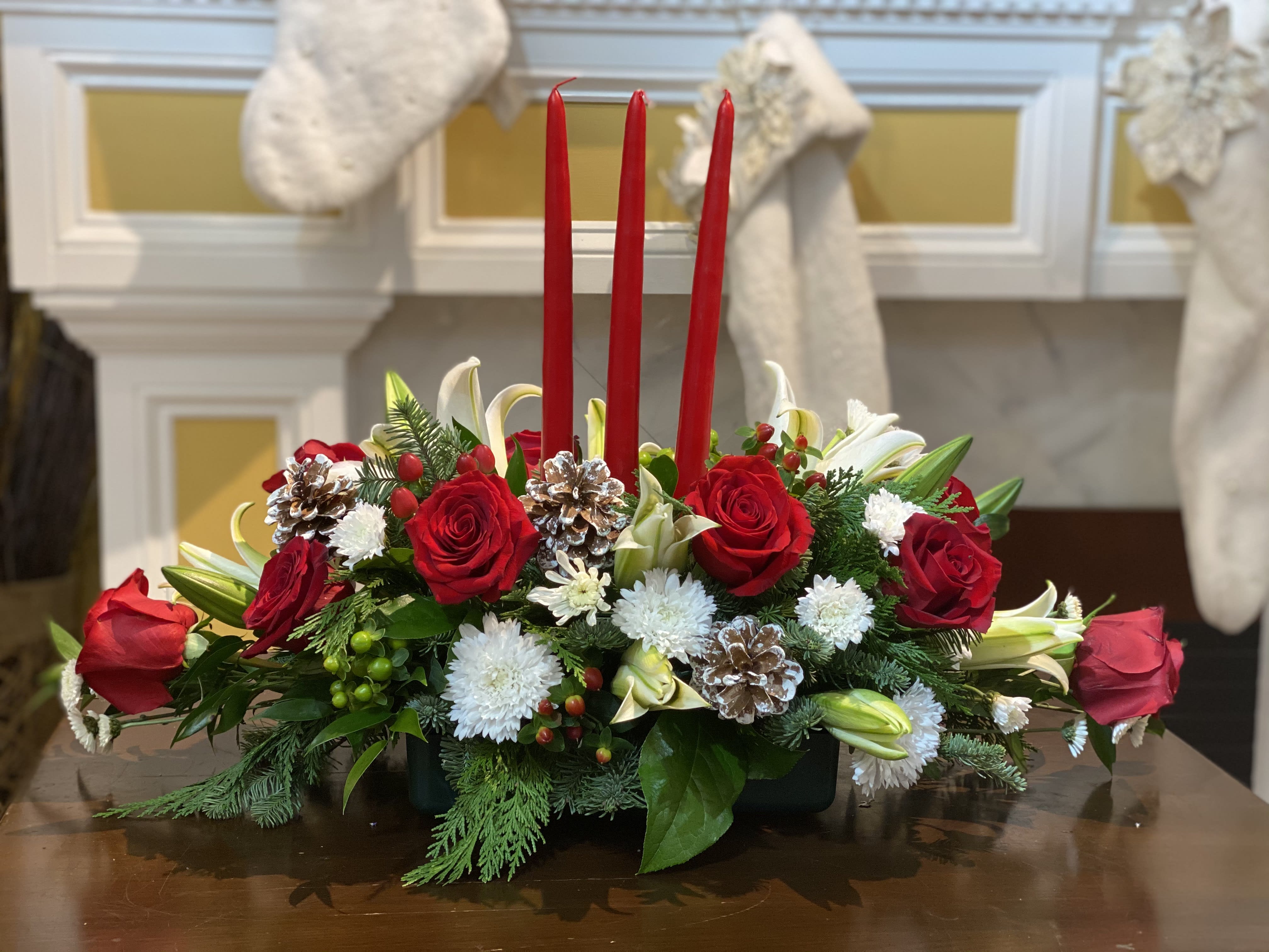 Festive Elegance - Add a festive touch to your Christmas dinner table with this captivating centerpiece. A combination of Rose, Oriental lily, and ever greens brings the scent of Holidays to you.
