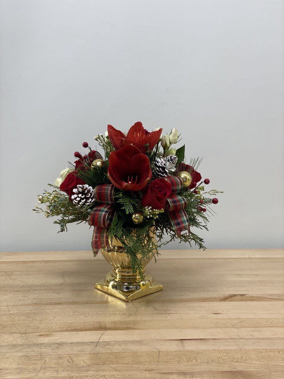 Golden Spirit  - An arrangement of red roses and evergreens in a beautiful golden ceramic pedestal, a perfect gift to celebrate the bright spirit of Christmas.