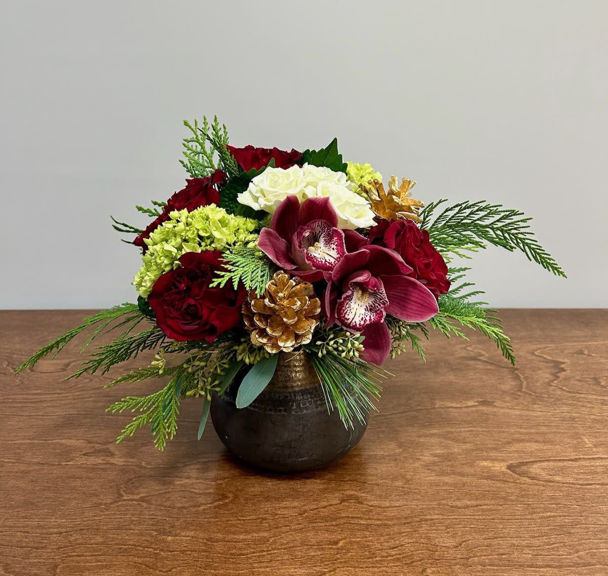 Garnet and Gold - This flower arrangement is not only a feast for the eyes but also a celebration of love and joy. The combination of hearts roses, mini green hydrangea, burgundy cymbidium orchids, and gold pinecones in a copper vase creates a striking and memorable centerpiece, making it a perfect gift for a special occasion or a stunning addition to any festive event.
