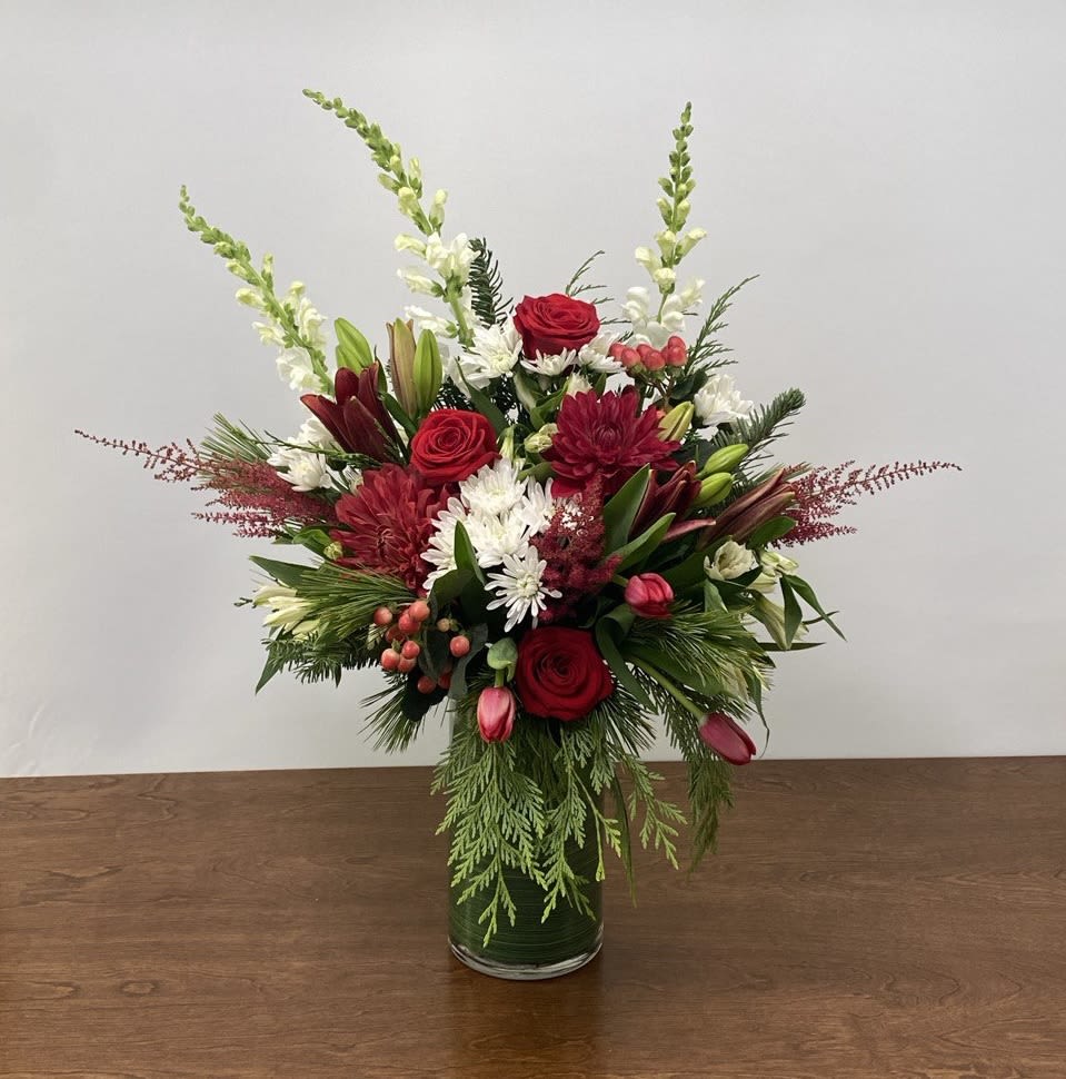 Holiday Garden - A showy and festive array of reds and whites with evergreens - it's the Christmastime cousin of our very popular Autumn Garden arrangement.