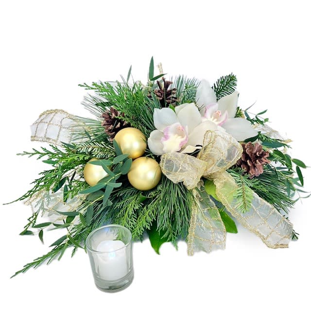 Festive Glow - Transform any festive gathering with 'Festive Glow'. A masterpiece of refined sophistication, this centerpiece captures the essence of the season with lush evergreen, delicate white orchids, festive pinecones, and glistening gold baubles. Adorned with a touch of opulent gold ribbon, it exudes an air of timeless beauty and holiday charm. Elevate any table with this elegant creation that seamlessly blends natural allure with festive opulence. Send the magic of the season with a centerpiece that stands as a symbol of luxury and winter wonder.