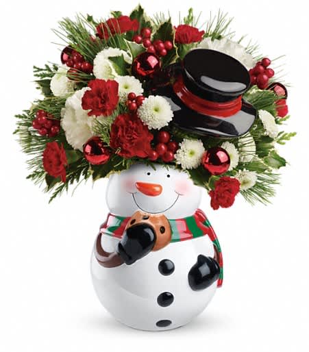 Teleflora's Sweet Snowman Bouquet - Break out the milk and cookies! White carnations, miniature red carnations and white button spray chrysanthemums are arranged in our adorable Snowman Cookie Jar. Holiday wishes have never been sweeter.
