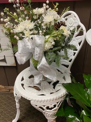 White Christmas - This stunning all white holiday arrangement is filled with Christmas greens and all best white flowers of the season. 