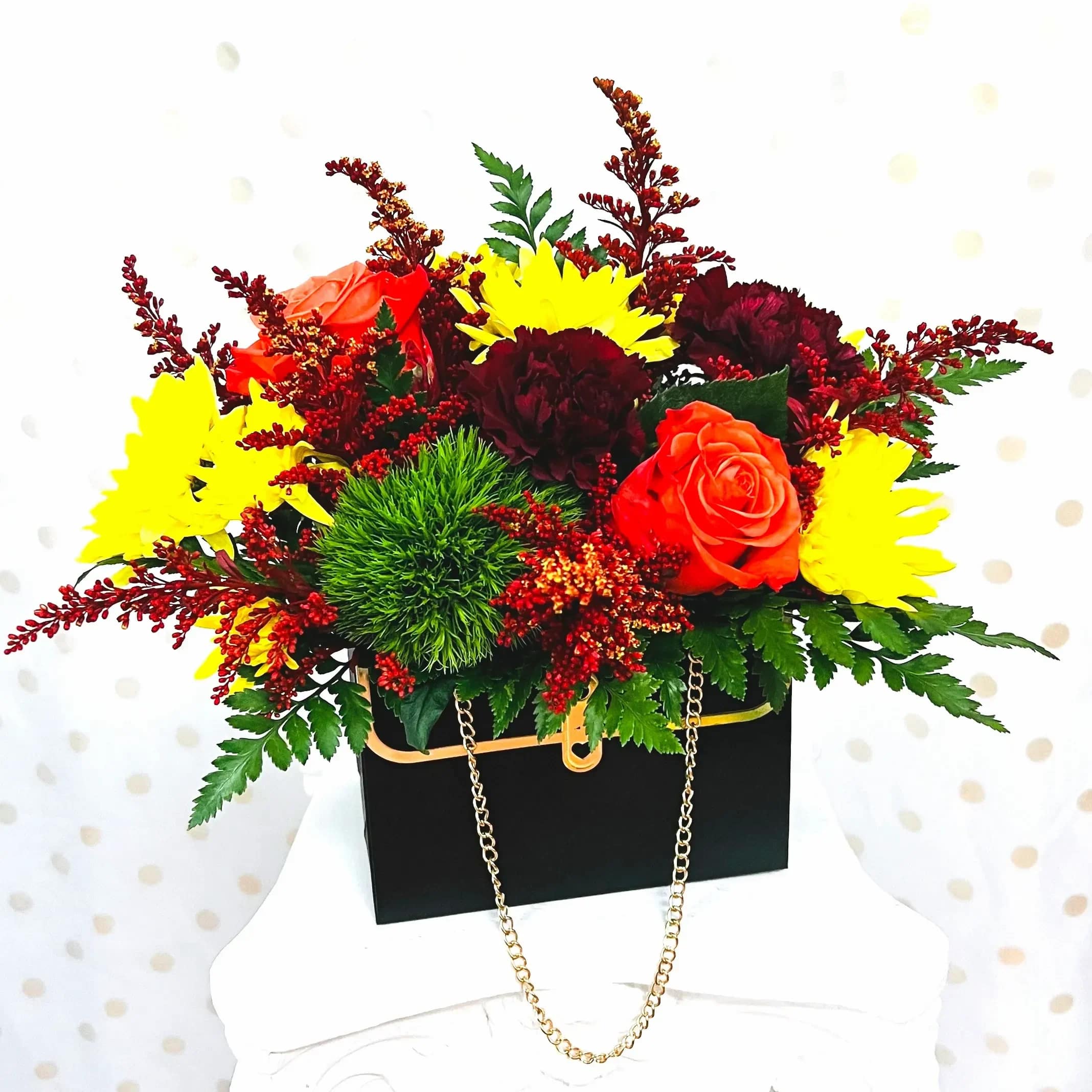 Posh Petals - Feeling fancy? Send Posh Petals!  Gerbera daisy, chrysanthemum, waxflower, roses, spray carnations, dianthus, and salal foliage fill this darling purse floral holder to the brim!  Flowers and colors may vary but will be substituted for equal or higher value. Purse colors may vary.