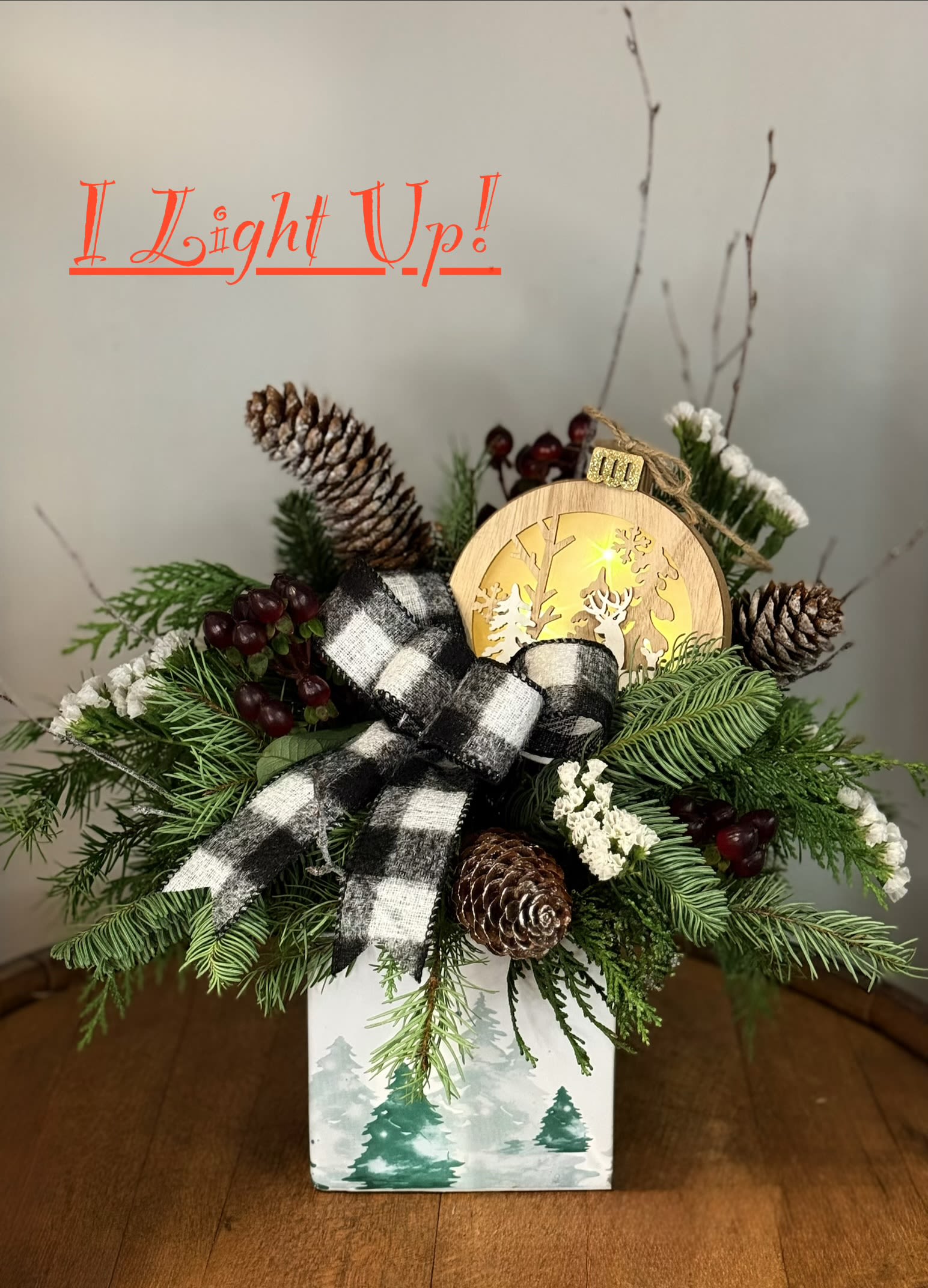 Twilight in the Pines - This cozy, woodland arrangement is a reminder of simpler times and love, family, and tradition. With a light up ornament to tuck into it, who wouldn't love this Christmas arrangement!