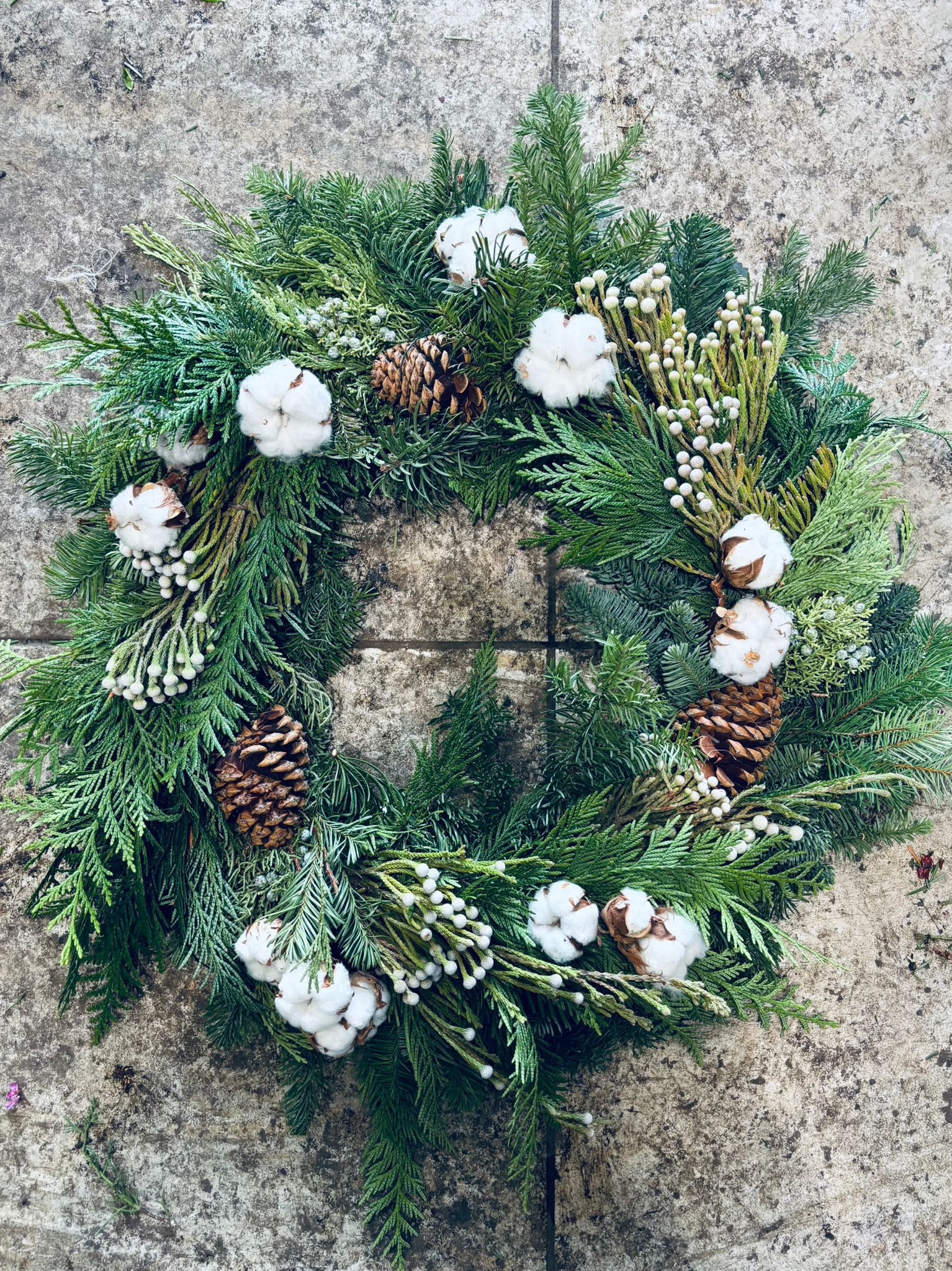 Winter Greenery Wreath 4 - This 20” holiday wreath features lush seasonal greens, cotton ball, and soft accents for a cheerful winter display.