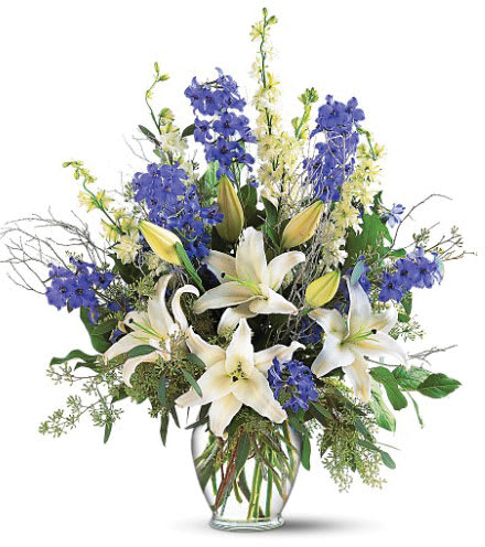 Sapphire Miracle Bouquet - Brighten a room with this gorgeous arrangement filled with blue delphinium, white larkspur and lilies in a clear glass ginger-shaped vase. 