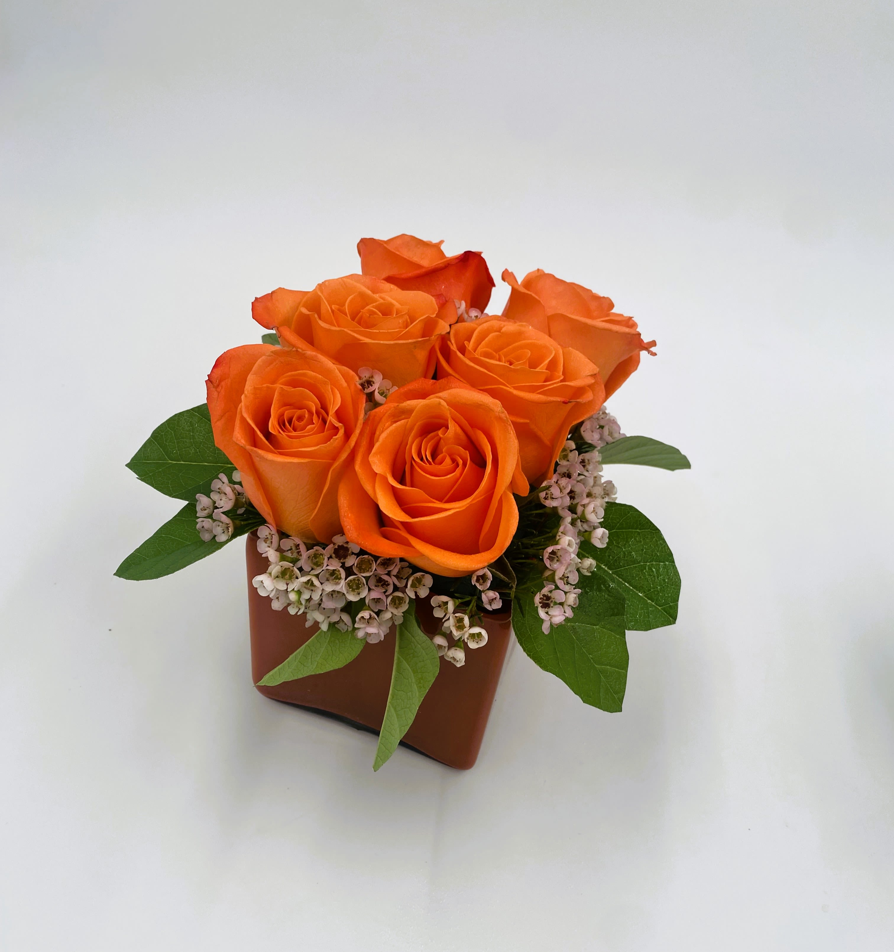 Pave Roses Arrangement - A modern twist on timeless roses, this pavé design features lush blooms nestled closely together for a chic, garden-inspired look. The standard has 6 roses, the deluxe has 9 and the premium has a dozen. Perfectly compact yet bursting with elegance, it’s an arrangement that feels both stylish and romantic—ideal for birthdays, anniversaries, or simply to brighten someone’s day with a touch of charm.    Please note: Flower varieties and colors may be substituted based on seasonal and daily availability. We always ensure your arrangement is of equal or greater value and just as beautiful.