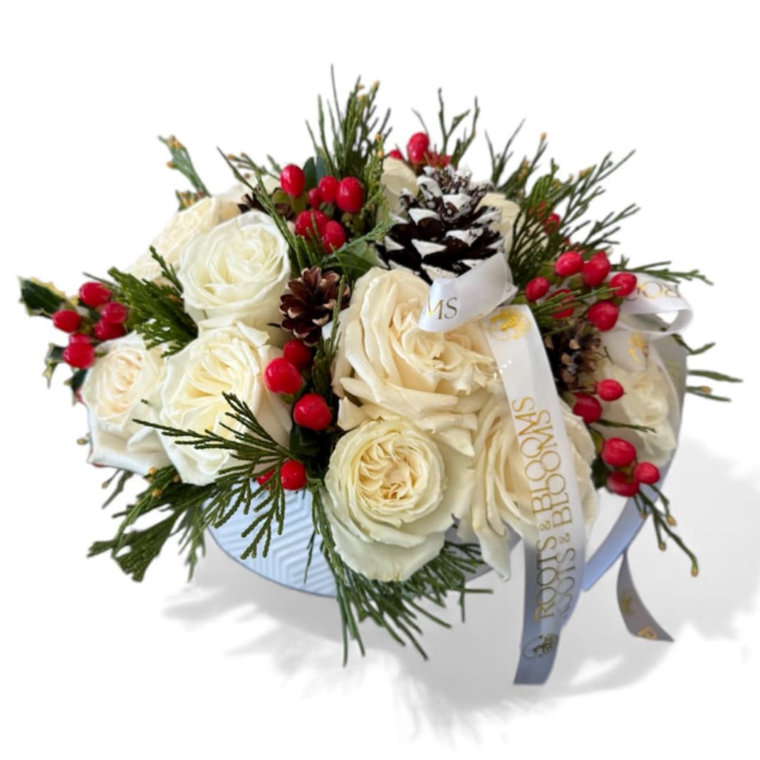 Winter Wishes - Our cozy holiday arrangement dressed in creamy roses, berries, and frosted pinecones. Perfect for gifting or warming up any room this season. 