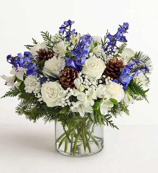 Happy Hanukkah Bouquet  - Inspired by winter’s cool blue and white landscape, our arrangement delivers warm wishes to those you love. The lush gathering of blooms, evergreens, and rustic touches is a thoughtful sentiment filled with the season’s natural beauty; its palette is especially well suited for Hanukkah celebrations.