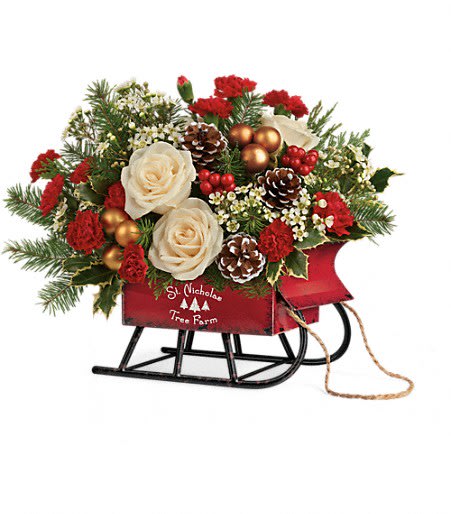 Teleflora's Joyful Sleigh Bouquet - This classic, hand-arranged Christmas bouquet, loaded with roses and winter greens, becomes an extra special delivery in this festive vintage sleigh!