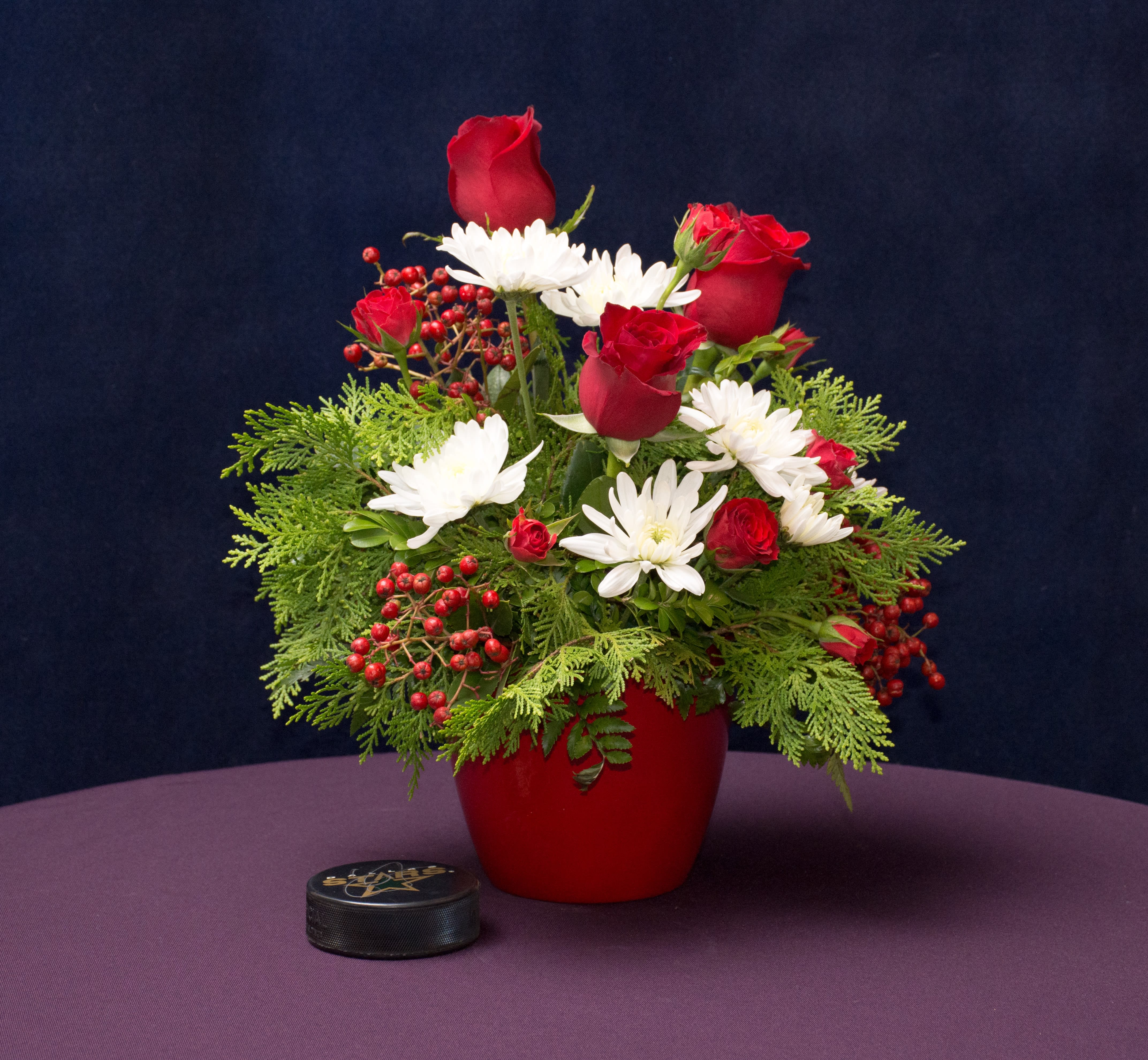 Joy to the World - Red and White Christmas flower arrangement with red roses, white poms, and beautiful  Christmas berries, that will certainly add a spark of delight to anyone's festivities. 