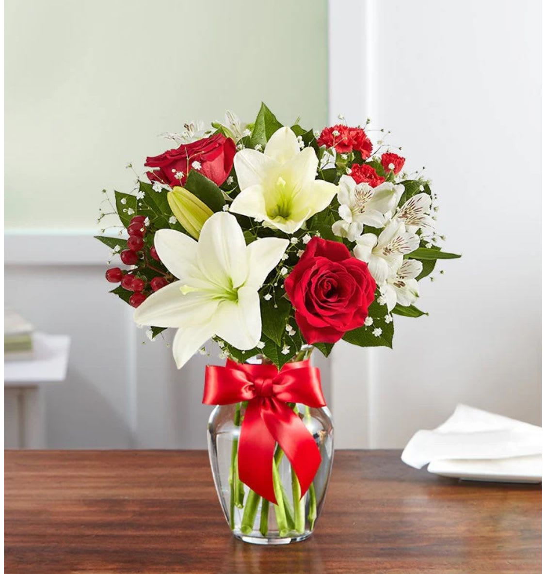 Holiday Cheer - Fresh-picked red &amp; white blooms are hand-arranged in a glass vase.   Please Note: Bow not included. Floral varieties and containers (vases) may vary due to local availability.