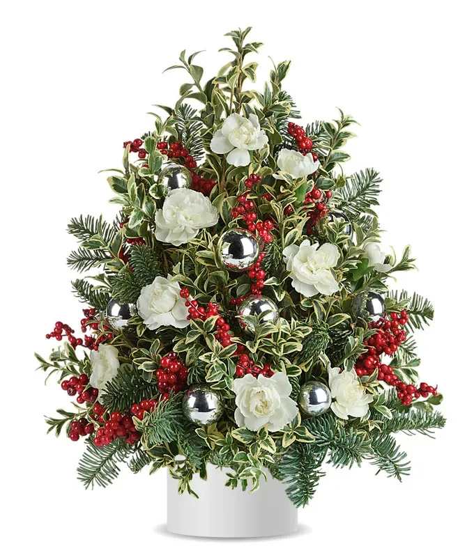 Snowy Christmas tree - This chic twist on a traditional Christmas tree is built from boxwood boughs and dotted with snowy white mini carnations, red berries