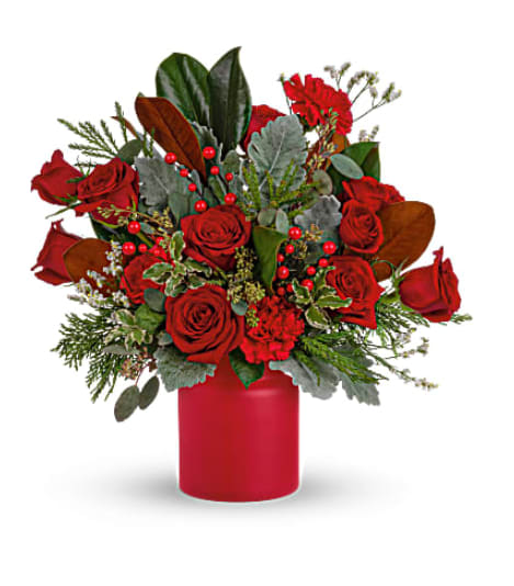 Teleflora's Wild &amp; Wonderful Christmas Bouquet - Simply unique, this gorgeous green and red design is artfully hand-arranged in a timeless matte red vase. Red roses, red carnations are surrounded by velvety dusty miller and various seasonal greens create an eye-catching wild &amp; wonderful look. Orientation: All-Around
