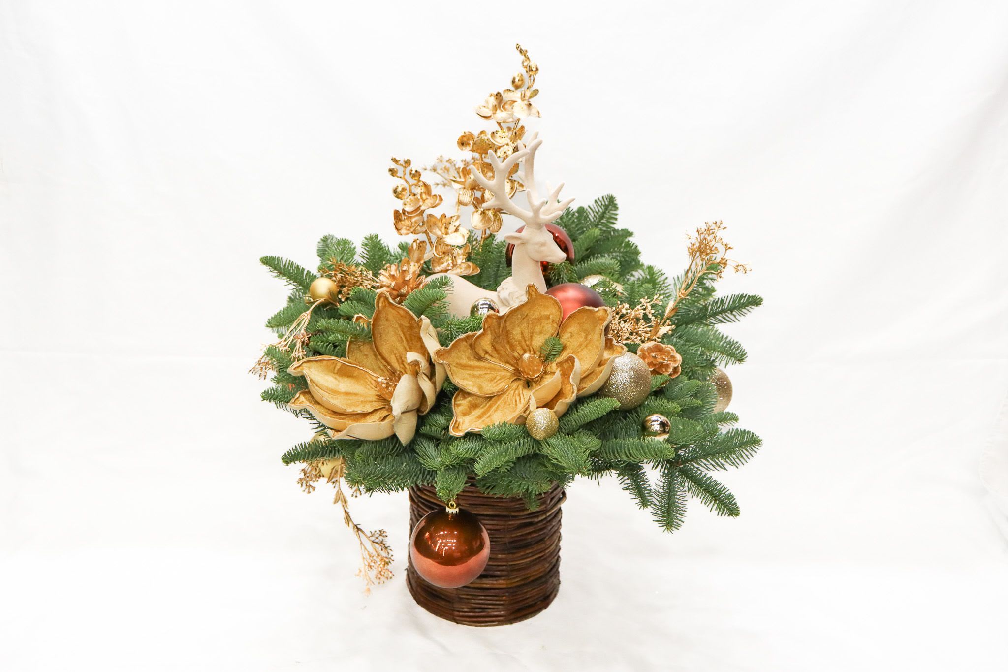  Golden Winter - Elevate your holiday décor with our Golden Winter Reindeer Arrangement, a stunning Christmas centerpiece designed to bring elegance and festive charm to your home. Featuring premium evergreen branches, gold-touched florals, sparkling ornaments, and a graceful reindeer figurine, this arrangement is the perfect addition to your Christmas table, mantel, or holiday gift list.  Crafted to capture the beauty of Christmas traditions, this piece adds warmth, style, and luxury to any room. Ideal for shoppers searching for Christmas arrangements, holiday centerpieces, evergreen displays, or premium Christmas décor.