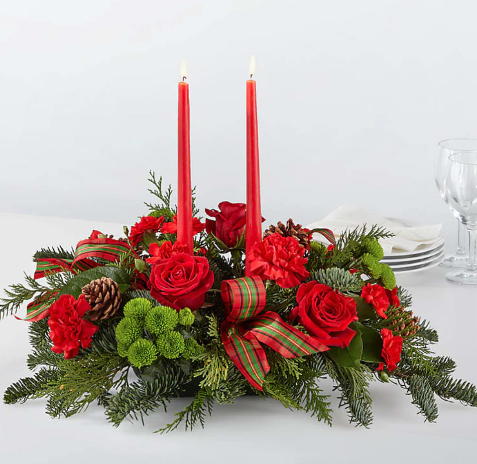 Christmas Centerpiece - A Christmas centerpiece around which fresh holiday memories unfold. There’s no finer tribute to a joyful homecoming than classic red roses paired with luxurious evergreens!