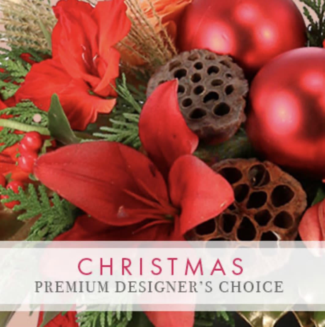 Christmas Premium Designers Choice - Our Premium Designer’s Choice allows our exceptional team to create a unique and festive holiday arrangement just for you. Let our designers craft something truly phenomenal to bring joy and winter cheer to your occasion. 