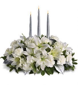 Silver Elegance Centerpiece - This silvery centerpiece is so elegant it practically speaks for itself. Perfect for a Christmas, New Year's or any other winter gala, its shimmery sophistication will light up the room.  Beautiful winter white hydrangea, roses, asiatic lilies, carnations and greens surround three exquisite silver taper candles. It's as graceful as it is grand.  Approximately 21&quot; W x 18 1/2&quot; H  Orientation: All-Around