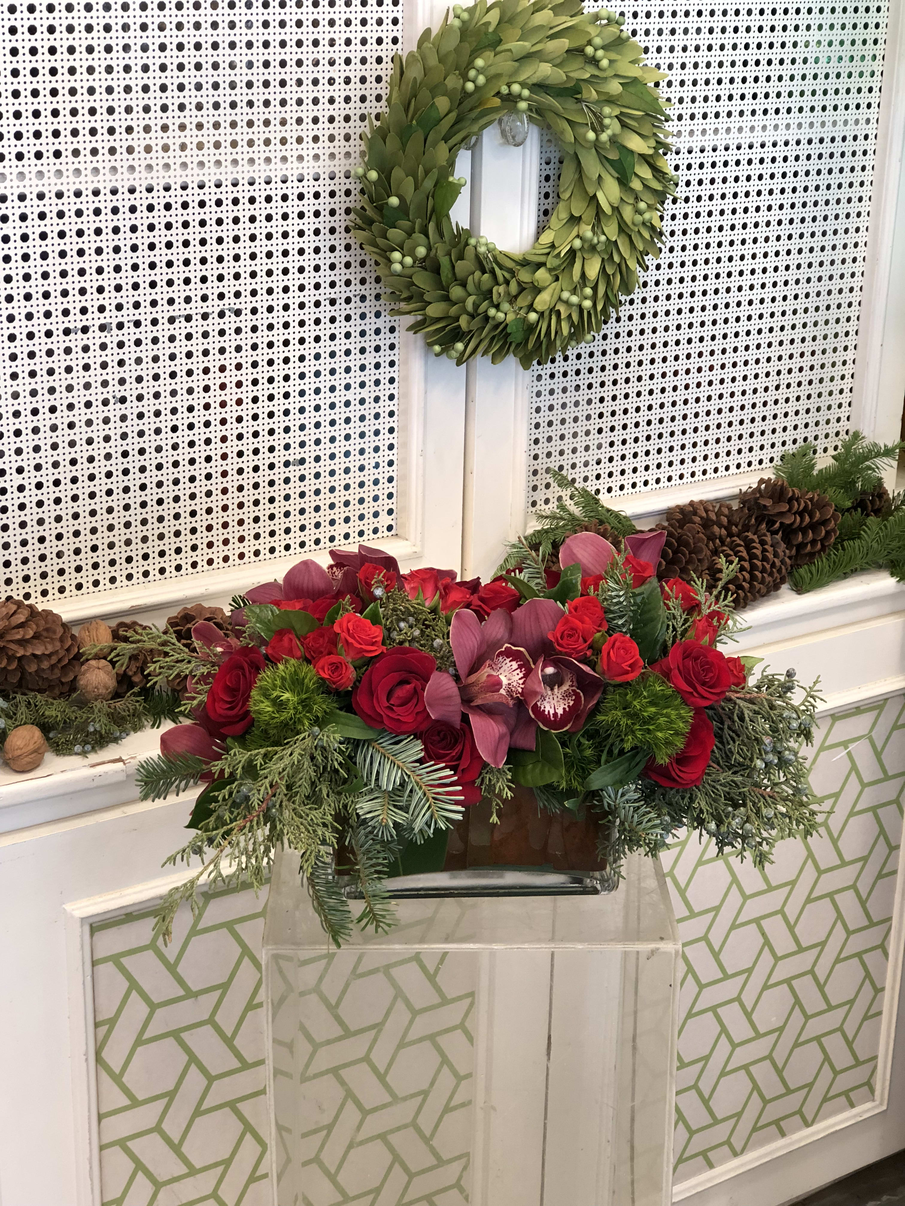 Red Vixen - Red Vixen is our elegant yet festive holiday arrangement of the season. Red Vixen is filled with cymbidium orchids, spray garden roses, explorer roses, and dianthus 