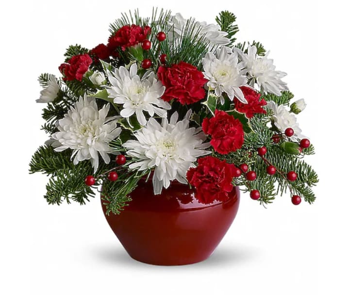 Christmas Treasure - So bright and festive, this gem of a holiday arrangement is sure to be treasured.  With all of the makings for a holiday celebration, with the perfect mix of red roses, carnations and berries, white chrysanthemums and winter greens including holly. Now how's that for jolly?