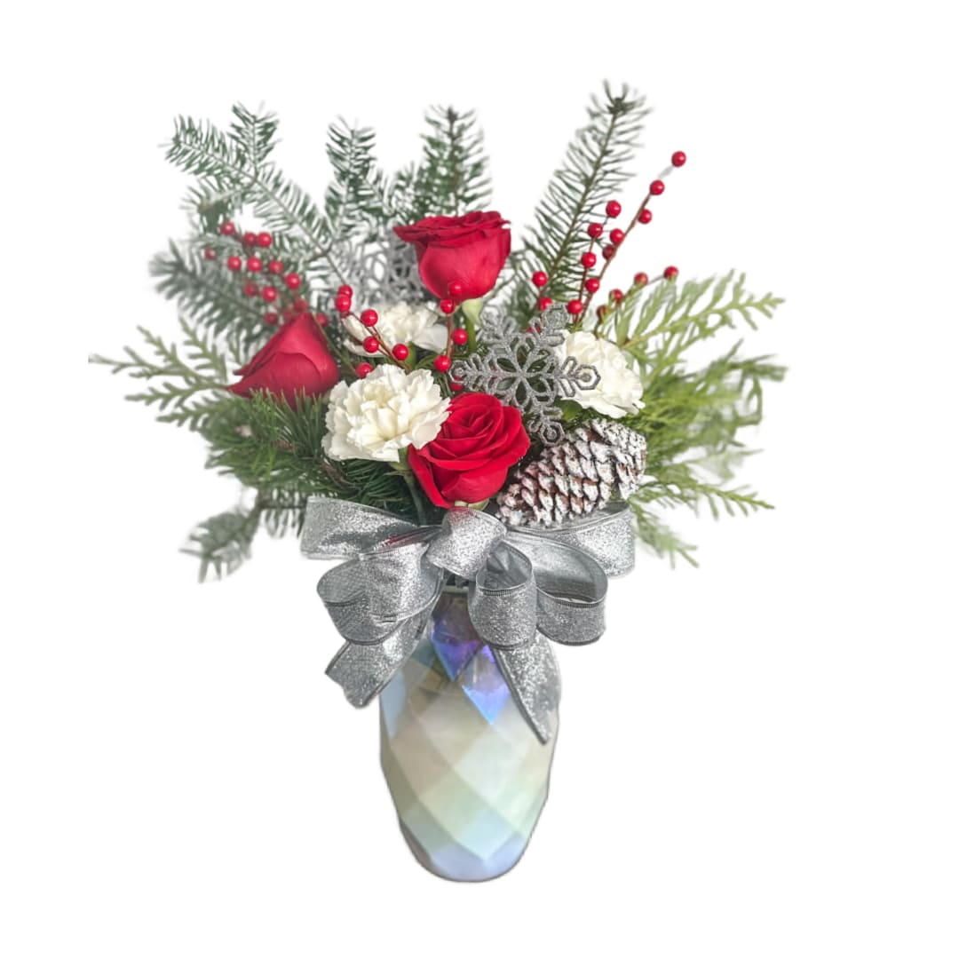 Christmas Elegance  - This is a statement piece! Its full of fresh Christmas greens and red flowers with a glitter bow. Blooms may vary depending on availability.
