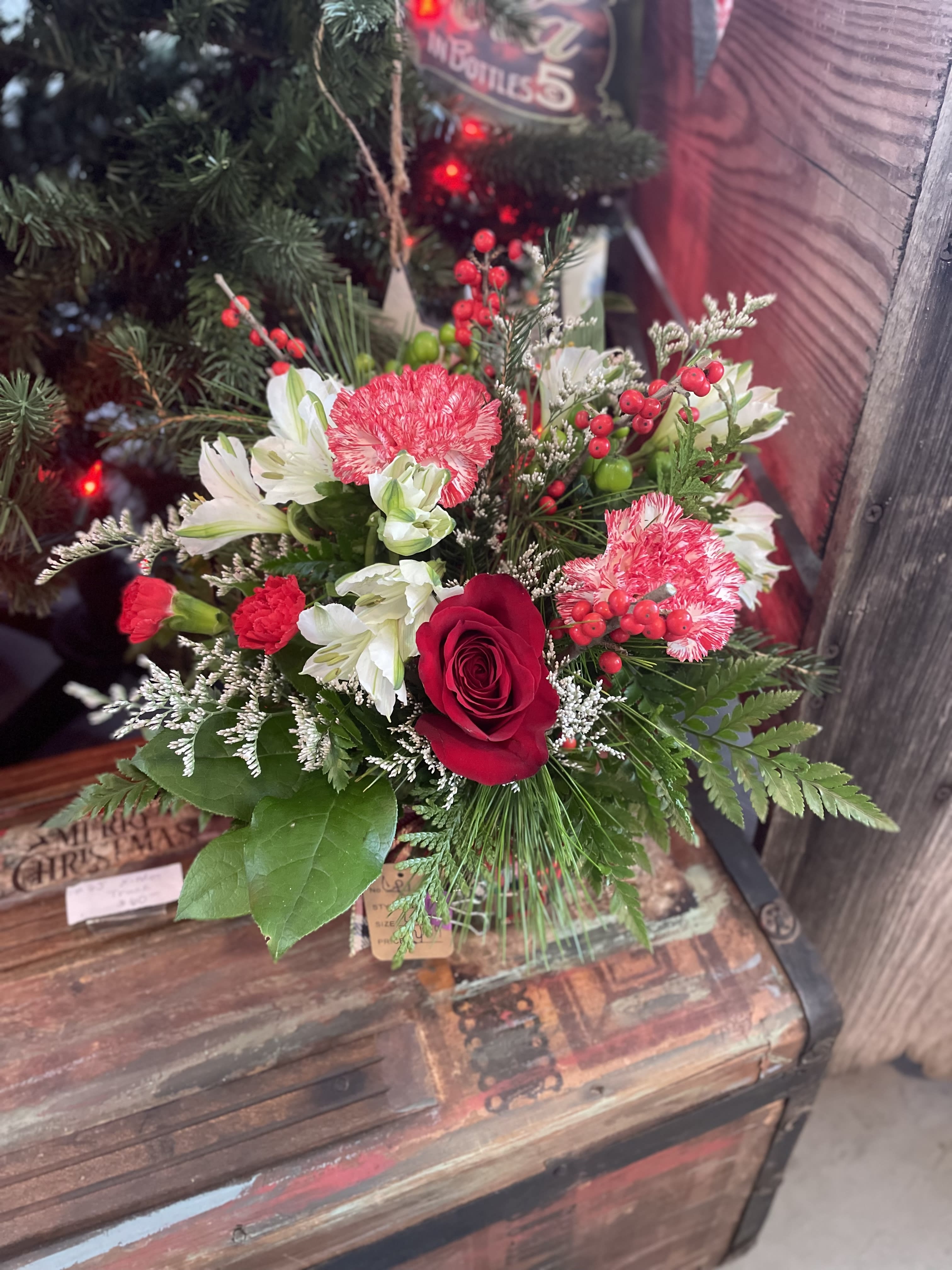 In Good Company  - And adorable, clear, read, bass, dressed with winterberry, peppermint carnations, roses and alstroemeria. this beautiful combination makes the perfect hostess gift to bring to any Christmas parties. 