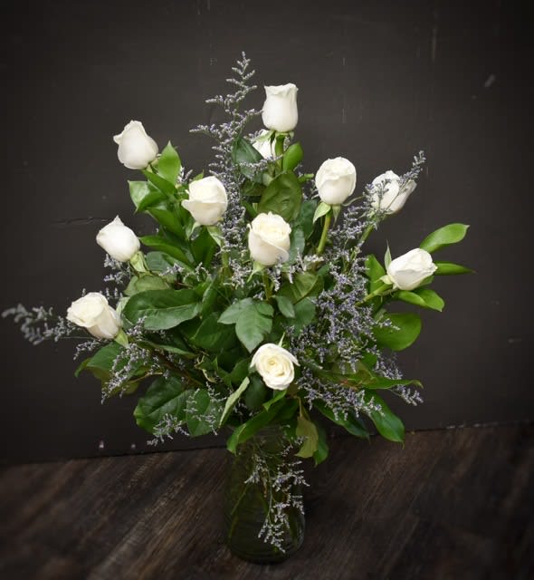 Enduring Love - White - A bouquet of our premium long stem creamy white roses designed in a glass vase with assorted foliages and babies breath.