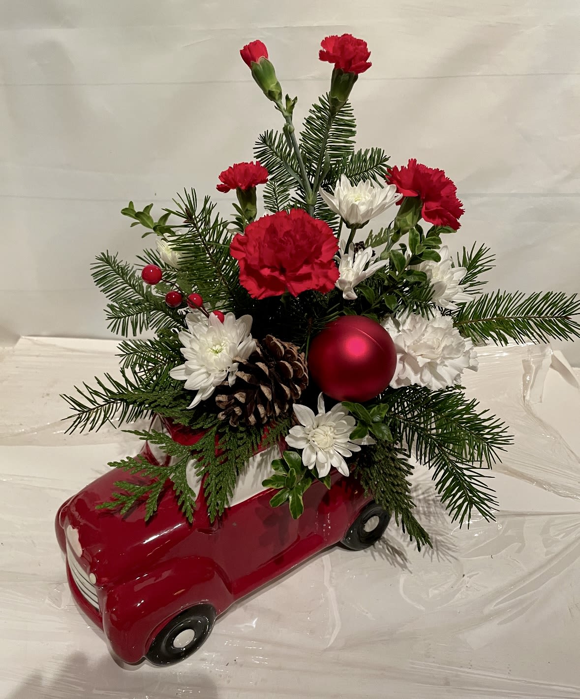 Truck Load of Cheer - This wonderful keepsake ceramic truck is hauling a truck load of holiday cheer! Filled with winter greenery and seasonal blossoms it’s sure to be a big hit this holiday season. Limited stock! Don’t miss out!