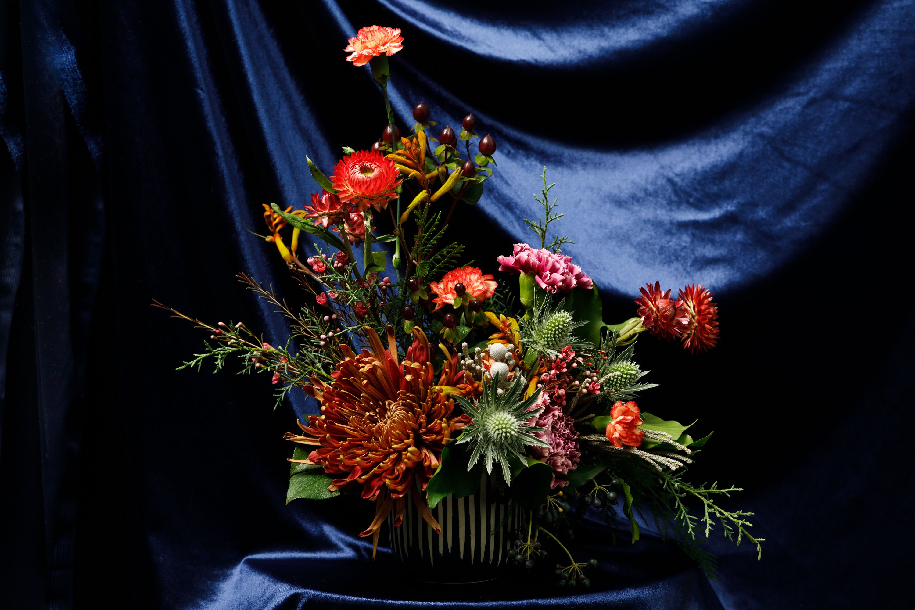 Bed-Stuy Collection: The Jefferson, Fall/Winter Edit   -  “The Jefferson” is our small, low &amp; lush, floral arrangement created in one of our hand-picked ceramic vases. The perfect size for any nightstand or vanity this tastefully arranged piece will set the tone for any room it sits in.   Each of our custom designs is created using fresh curated seasonal blooms and foliages. Designers will choose from a unique array of flowers to create an arrangement tailored for you. For special floral requests please place an order 4 days prior to the desired delivery date.   **Please note that Brooklyn Blooms move with the seasons, vessels, blooms, and foliage will vary from what you see in the photo. However, it will have the same beauty, uniqueness, and funky style. Please let us know in the florist notes if you have any color preferences or special requests. If you like what you see in the photo please let us know in the florist notes and the designers will use it as inspiration. Otherwise, the Bloomies will make a tasteful decision for you!**  ***ALL SPECIAL REQUESTS MUST BE SPECIFIED IN THE FLORIST NOTES SO THAT OUR BLOOMIES ARE AWARE AND CAN DELIVER THE BEST SERVICE. COMMUNICATION IS KEY!!****  Upgrade Notes: Please note that with each upgrade the Bloomies will choose a mix of blooms, premium foliages, and filler to enhance your arrangement for the best presentation!  