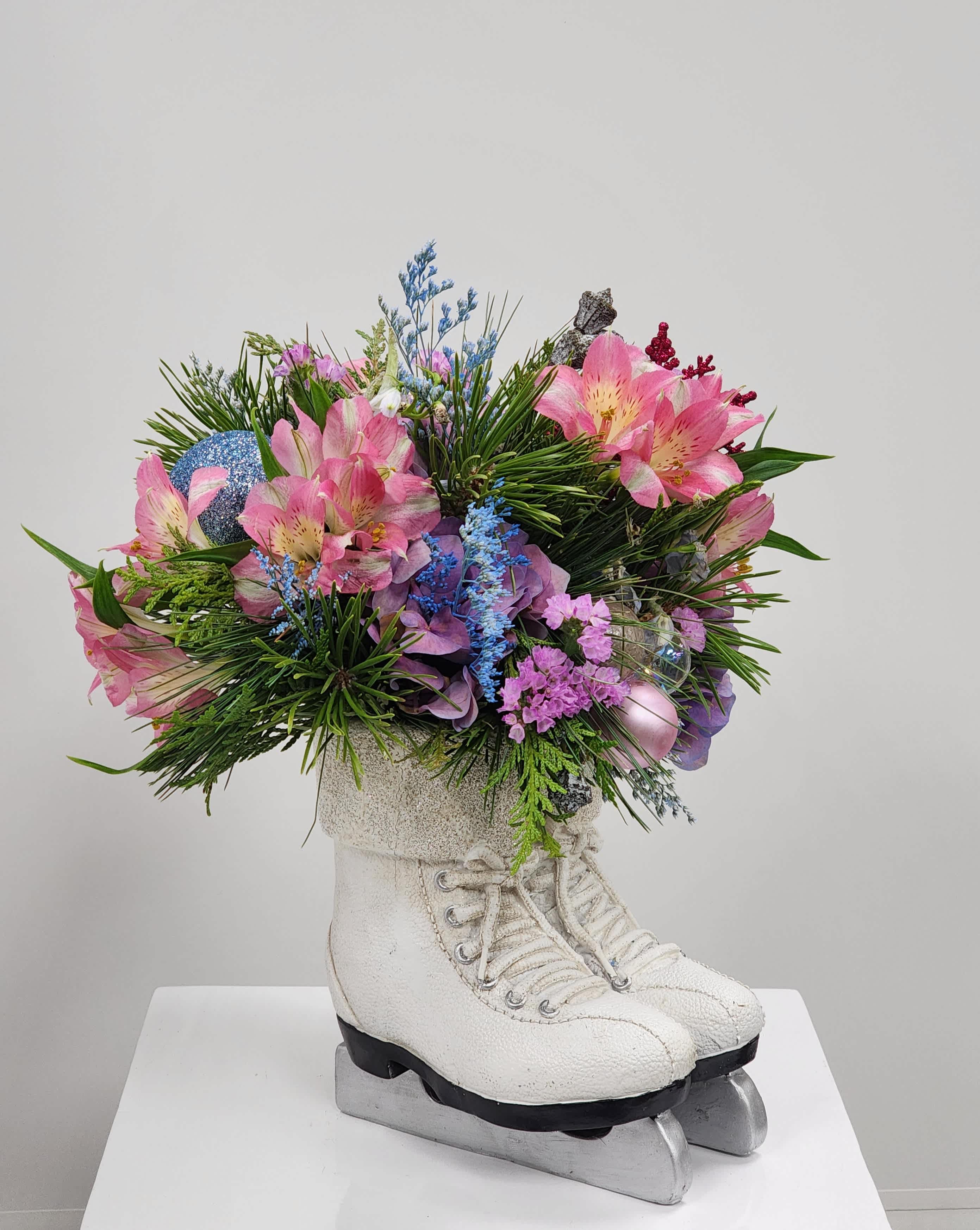 Ice Princess - Pick this adorable pair of ceramic skates filled with a colorful array of flowers. Filled with hydrangea, alstromeria, eucalyptus pods, bella donna, and accented with misty and statice.  Approximately 13&quot; tall by 11&quot; wide.