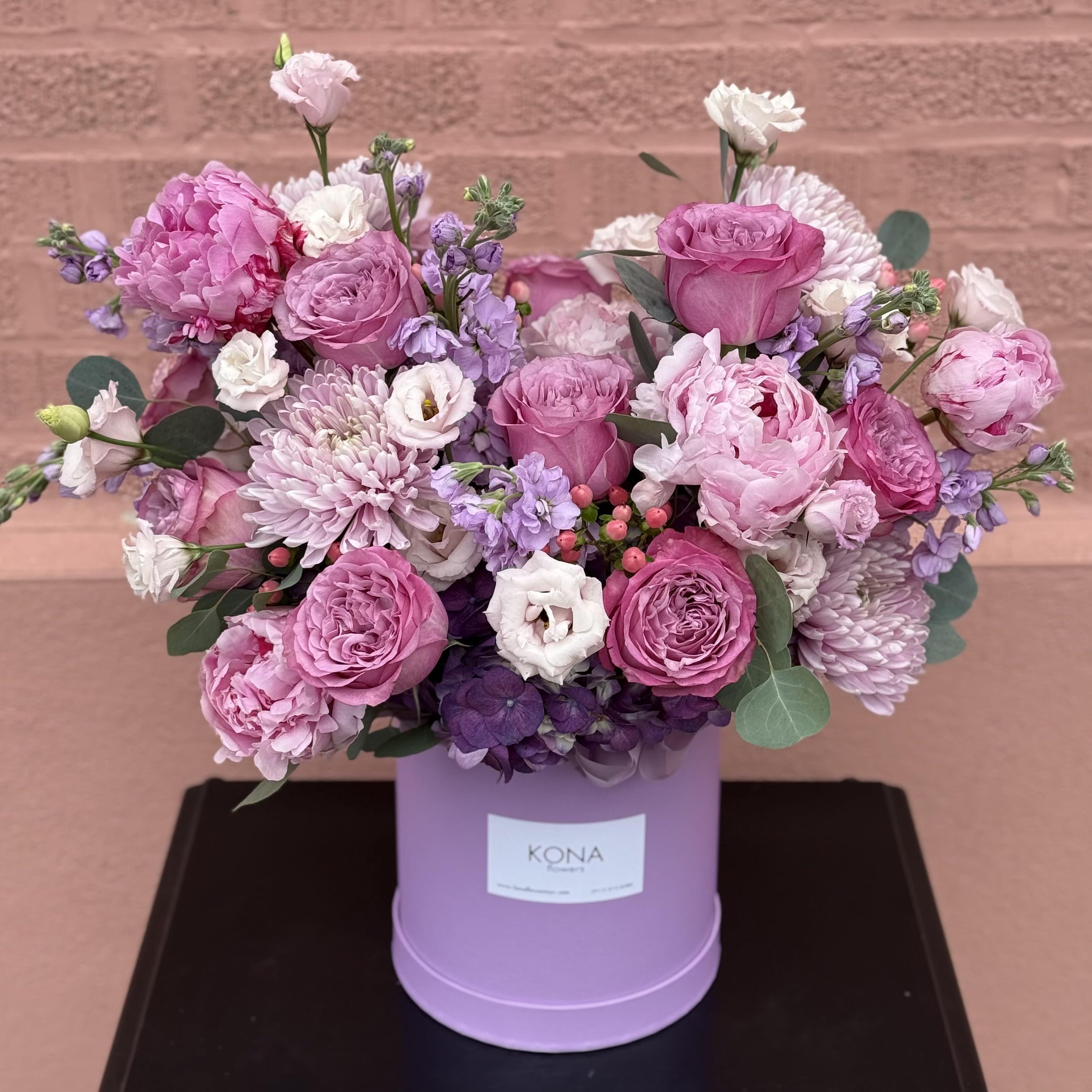 No. 387 - THE PHOTO SHOWS THE DELUXE SIZE  - Double-sided arrangement in a box.  The color scheme of the arrangement is lavender, purple and pink.  The photo shows the Deluxe size.