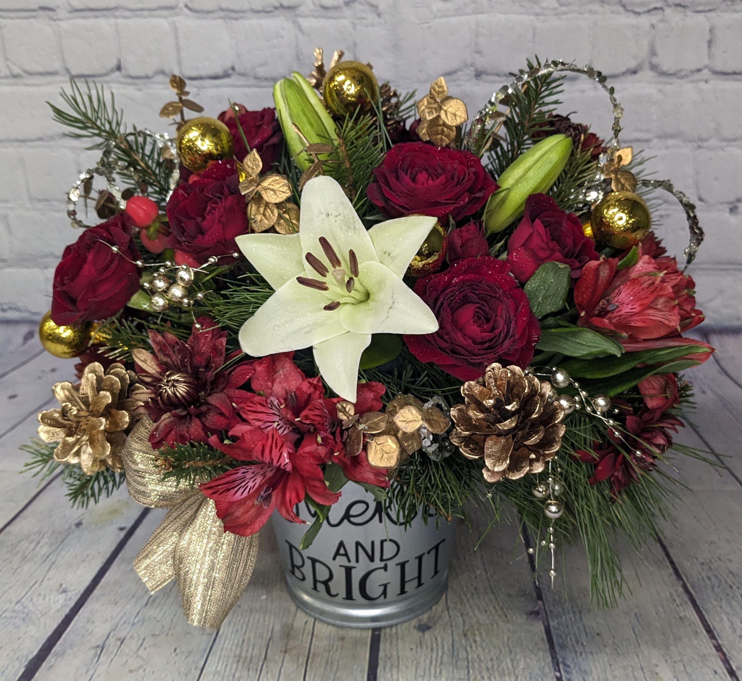 Merry &amp; Bright - Wish someone a merry Christmas with this bright holiday bouquet. Arrangement features: spray roses, white lilies, red chrysanthemums, alstroemeria, and glittery gold &amp; silver accents. 