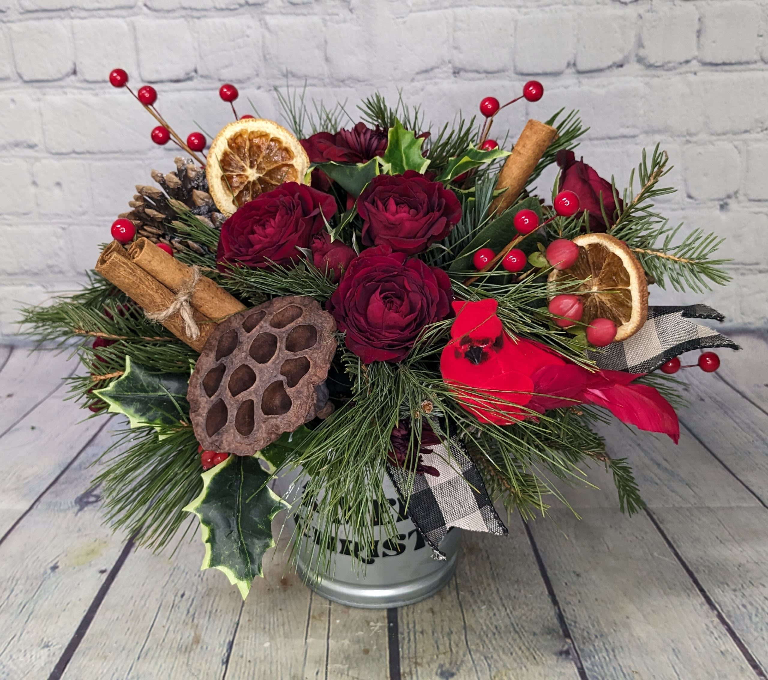 Woodland Christmas - A natural take on the traditional Christmas bouquet, our &quot;Woodland Christmas&quot; arrangement is filled with fresh mixed pine, dried orange slices, pine cones, lotus pods, cinnamon sticks, spray roses, red berries, chrysanthemums, and a cardinal pick. 